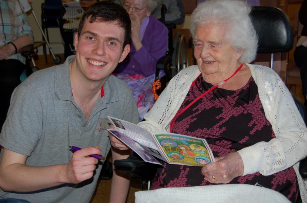 James McCreight signing a program (By kind permission of \'Cumbrae House Care Home in Glasgow\'.)